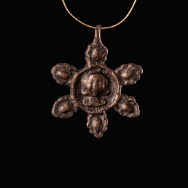 Medieval bronze harness pendant with central bust