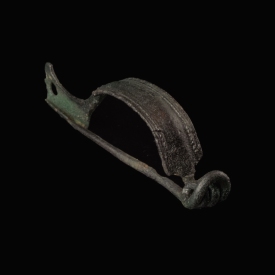 Ancient Roman bronze decorated bow fibula with wolf's head foot