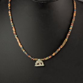 Necklace with ancient Egyptian multicoloured faience beads with a Goddess Nut as a sow amulet