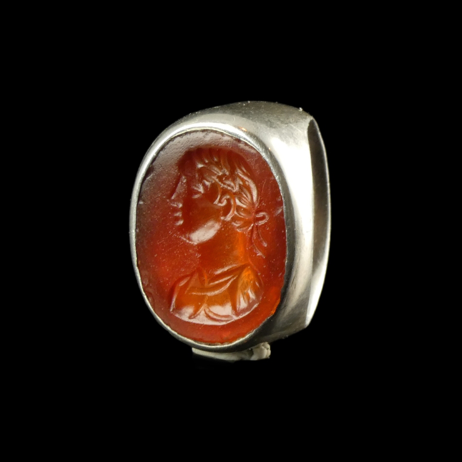 Ancient Roman carnelian intaglio with bust of Apollo, set in silver ring