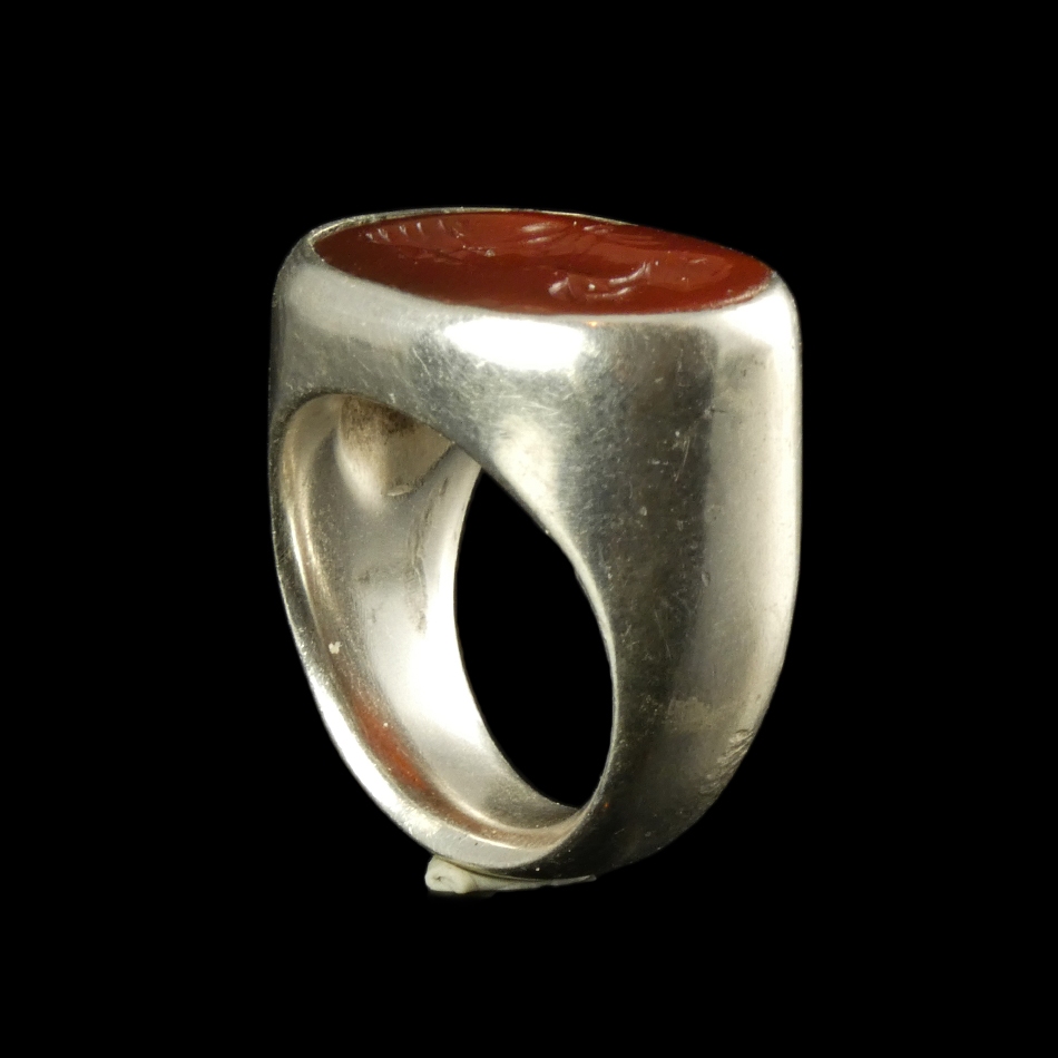 Ancient Roman carnelian intaglio with bust of Apollo, set in silver ring