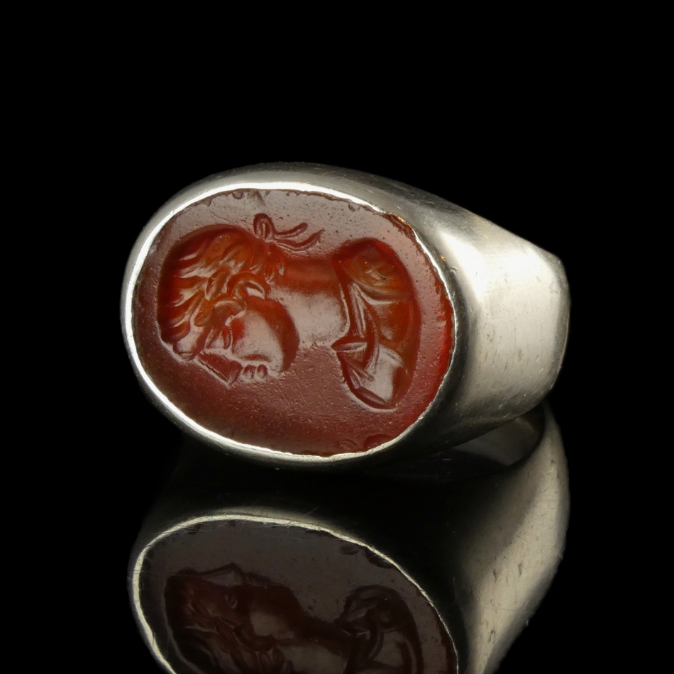 Ancient Roman carnelian intaglio with bust of Apollo, set in silver ring
