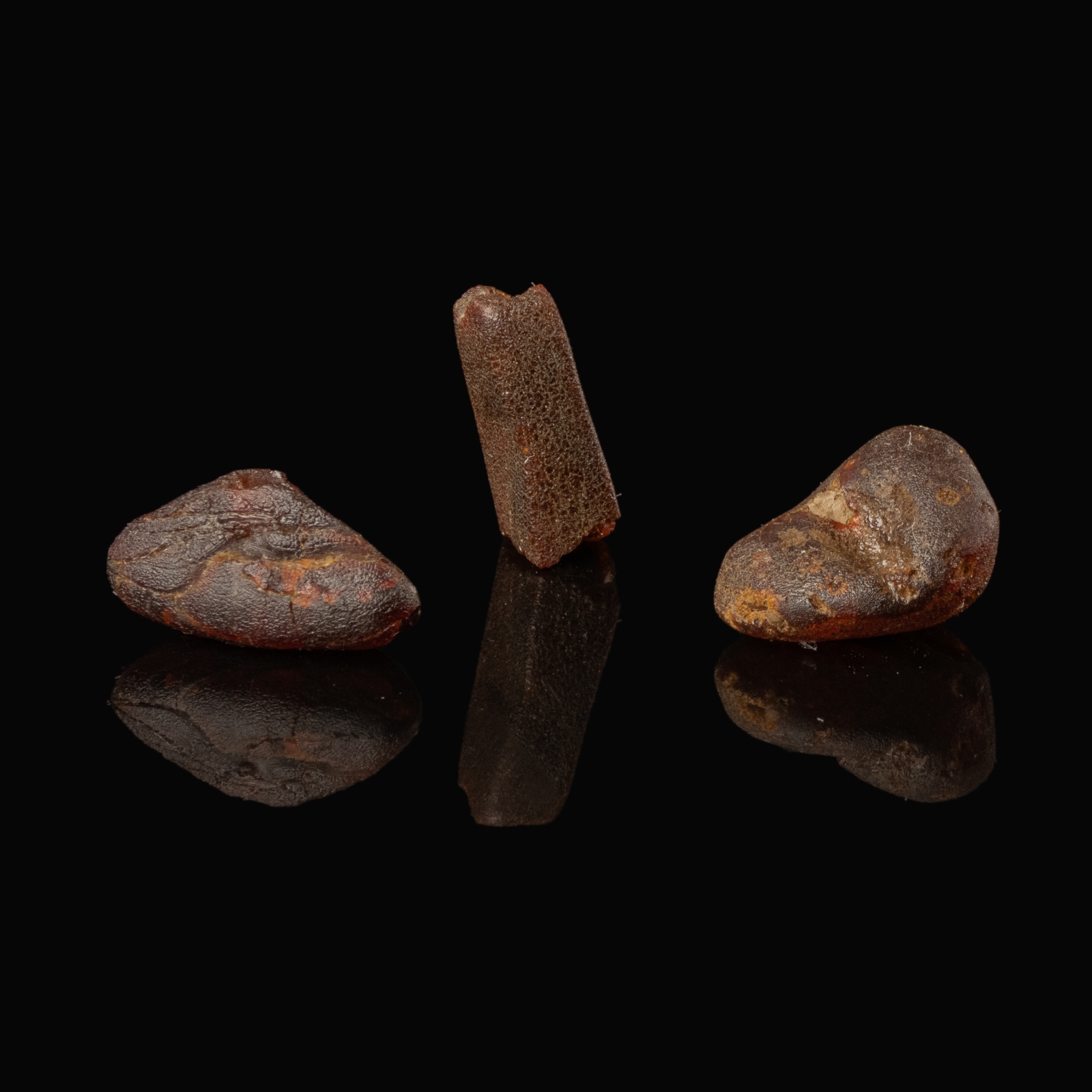 Collection of 3 Roman amber beads in display window
