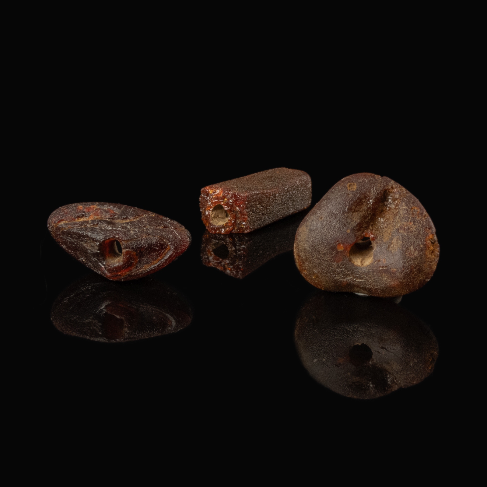 Collection of 3 Roman amber beads in display window