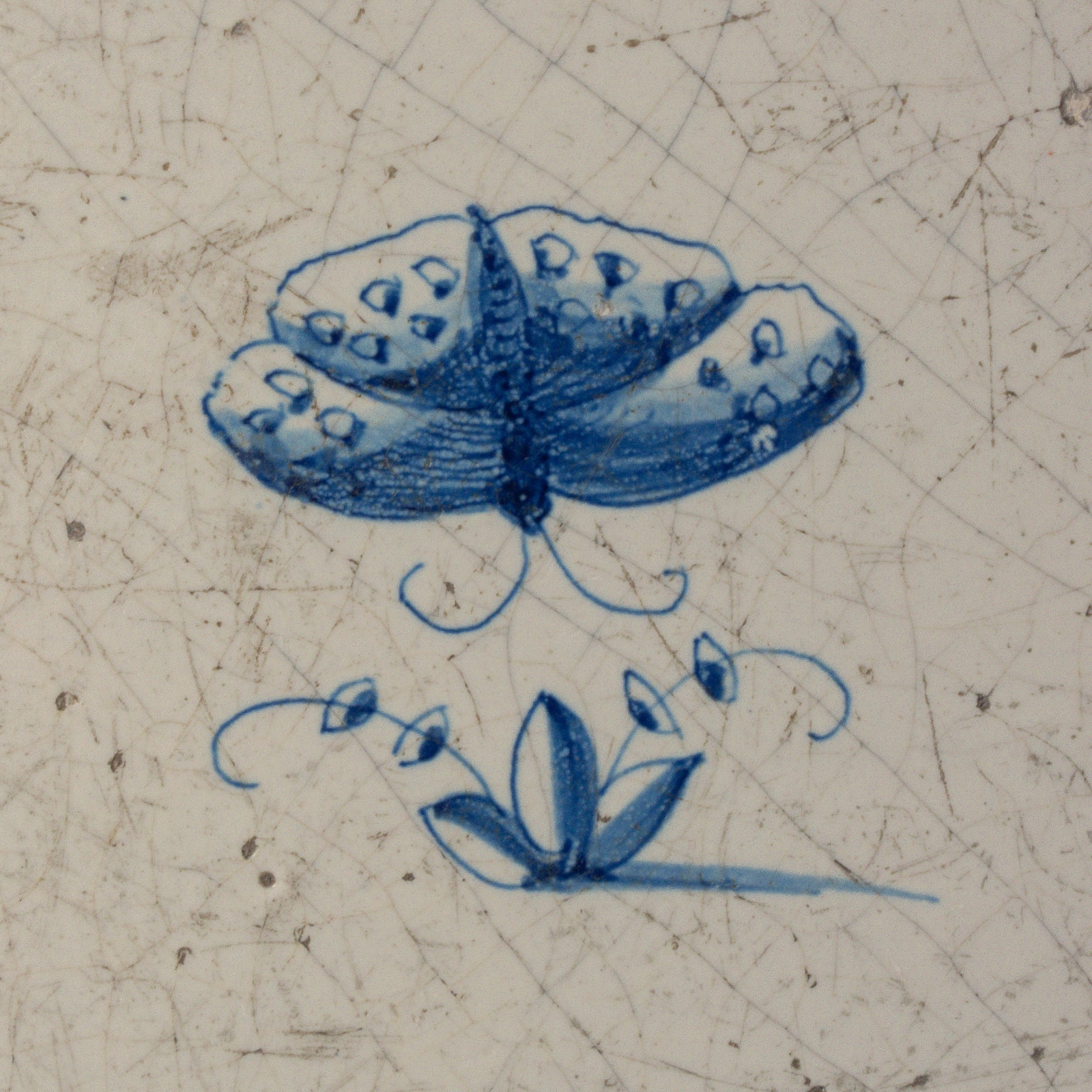 Dutch Delft blue and white tile with a butterfly
