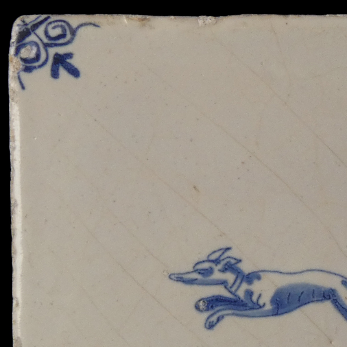 Dutch Delft blue and white tile with hunting dog