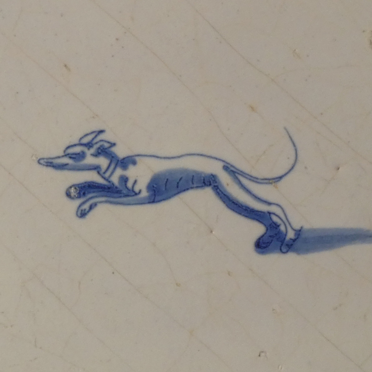 Dutch Delft blue and white tile with hunting dog