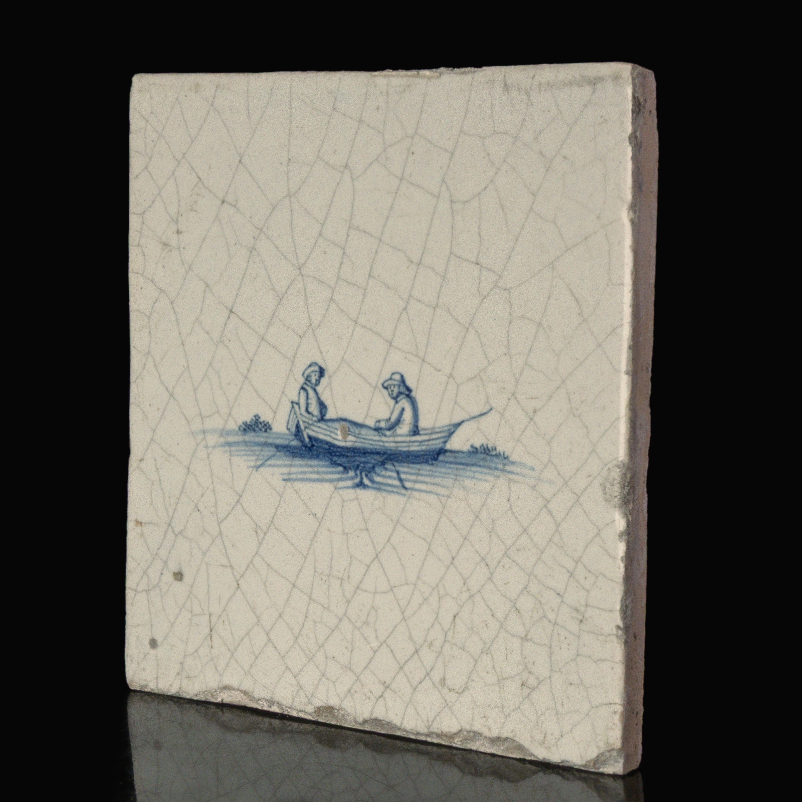 Dutch Delft blue and white tile with two people in a rowing boat