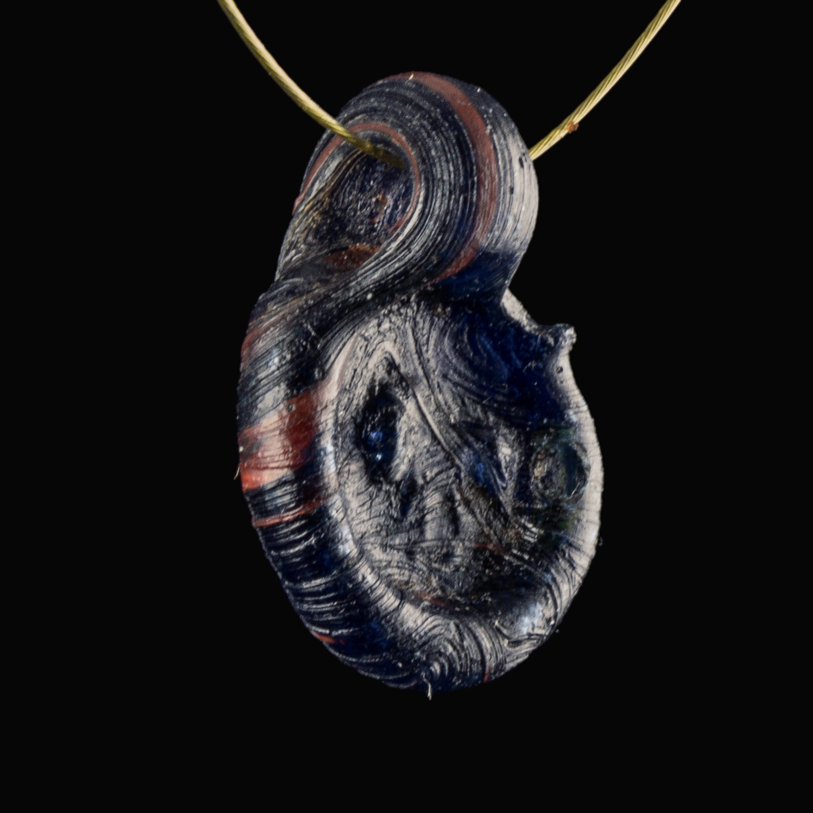 Late Roman bi-coloured glass amulet pendant with Lion