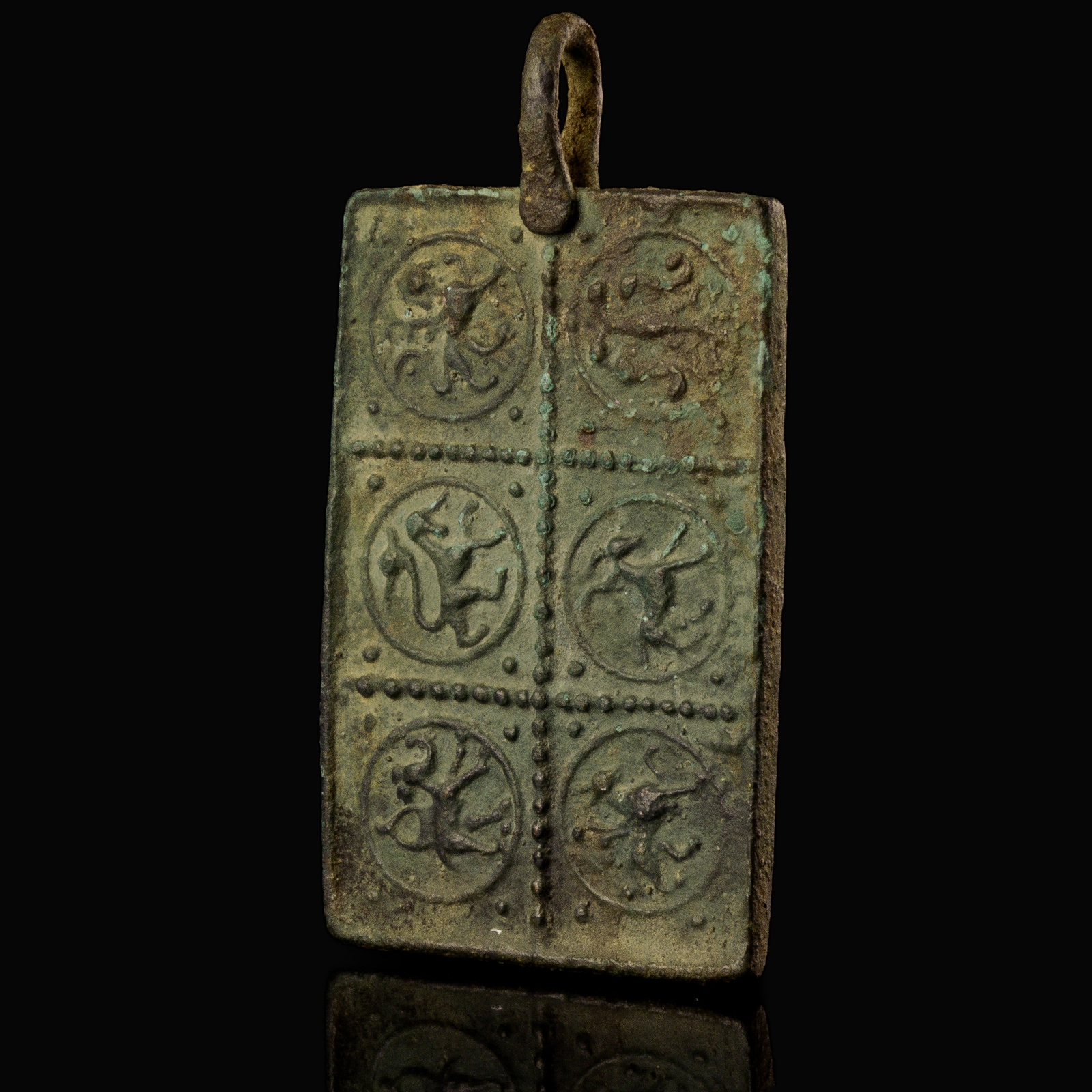 Medieval bronze harness pendant with a princely and protective bestiary