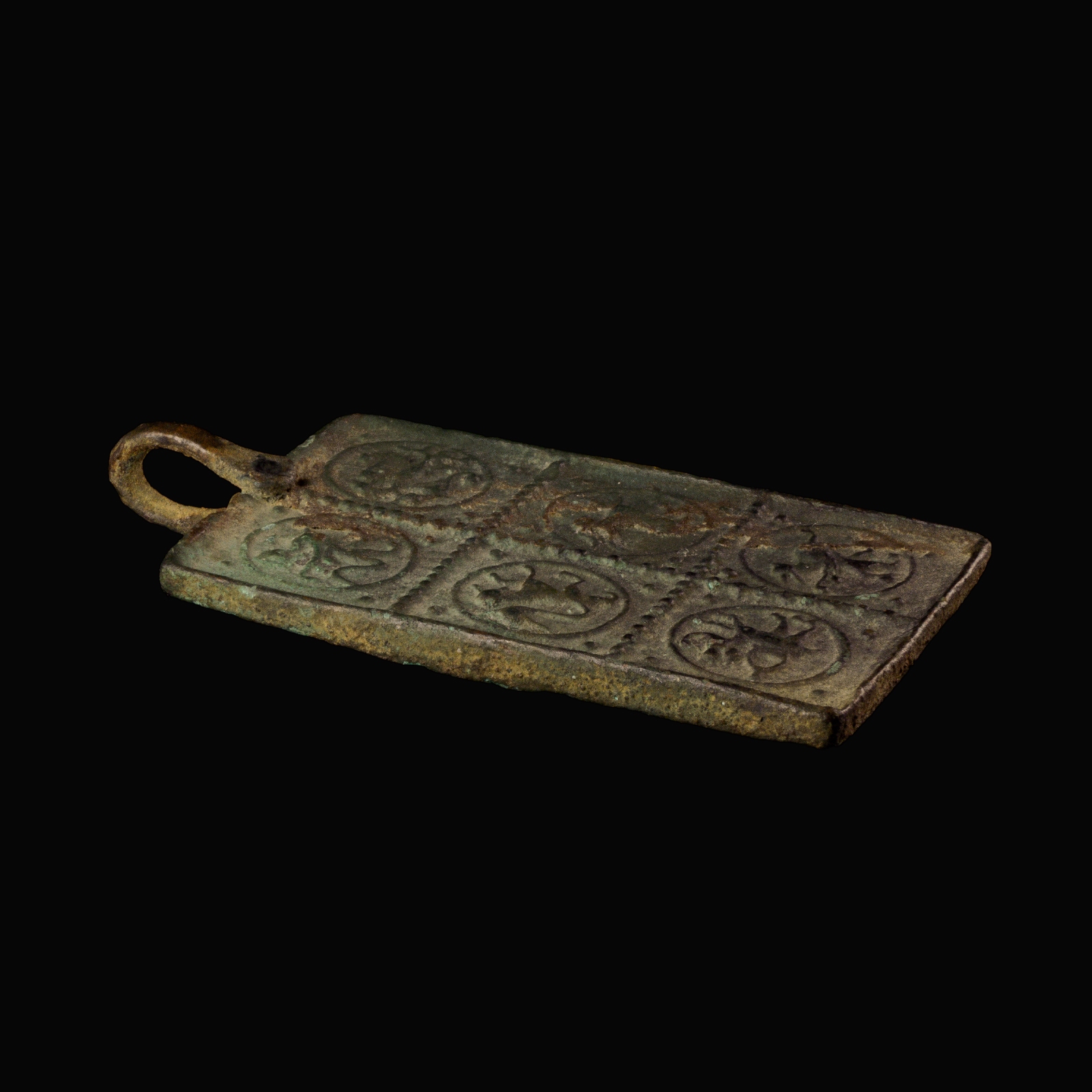 Medieval bronze harness pendant with a princely and protective bestiary