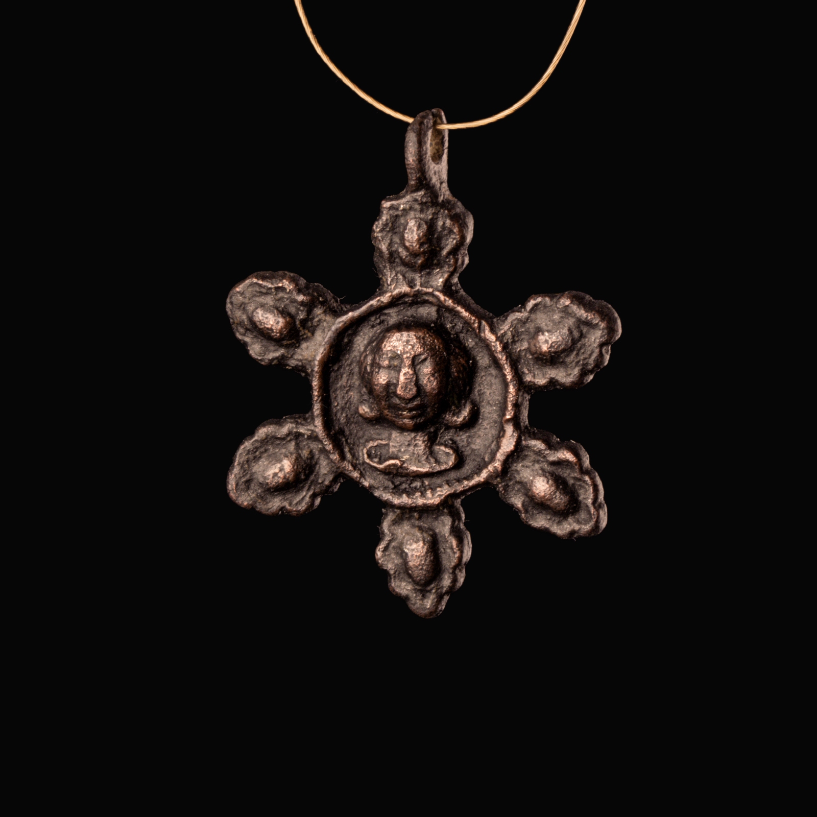 Medieval bronze harness pendant with central bust