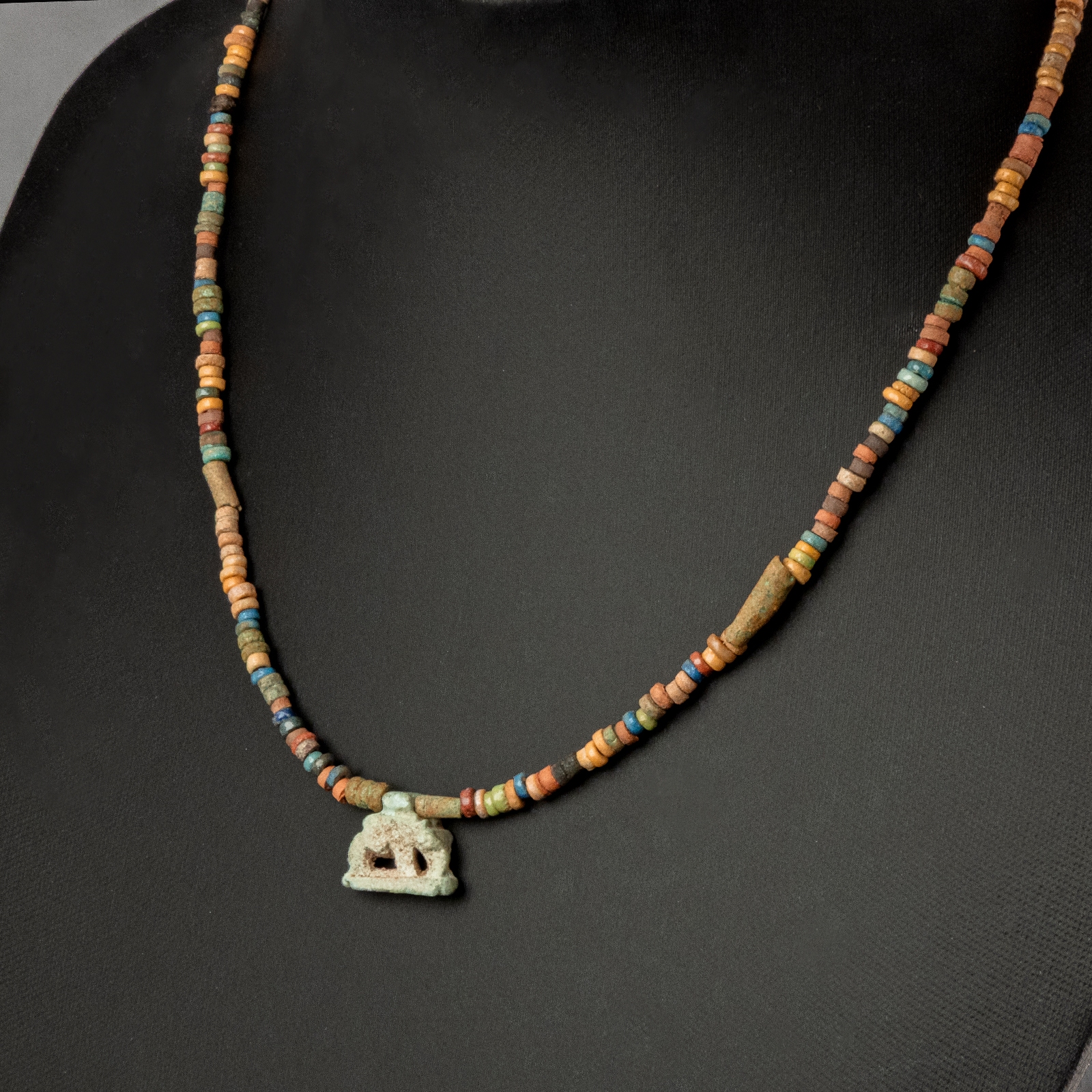 Necklace with ancient Egyptian multicoloured faience beads with a Goddess Nut as a sow amulet
