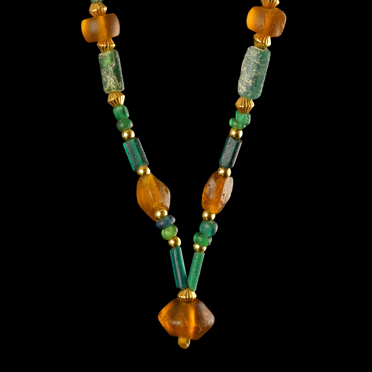Necklace with Roman green and amber coloured glass beads