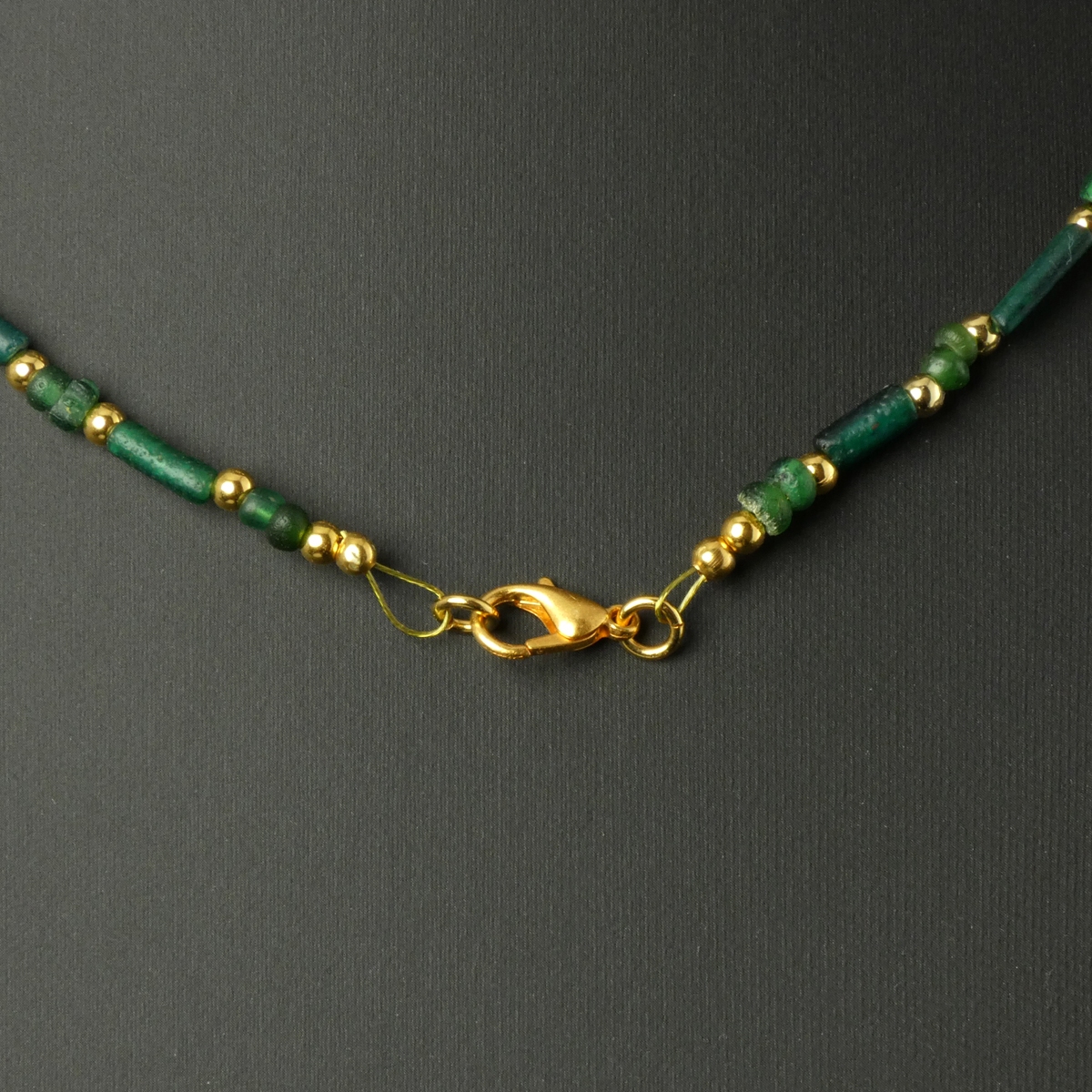 Necklace with Roman green and amber coloured glass beads