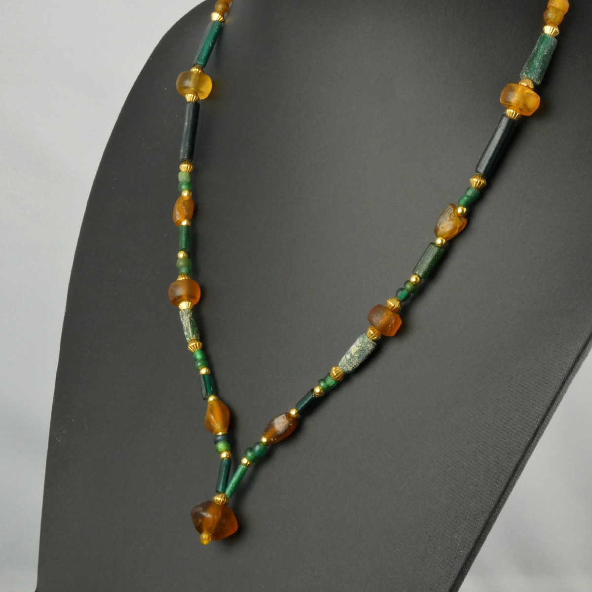 Necklace with Roman green and amber coloured glass beads