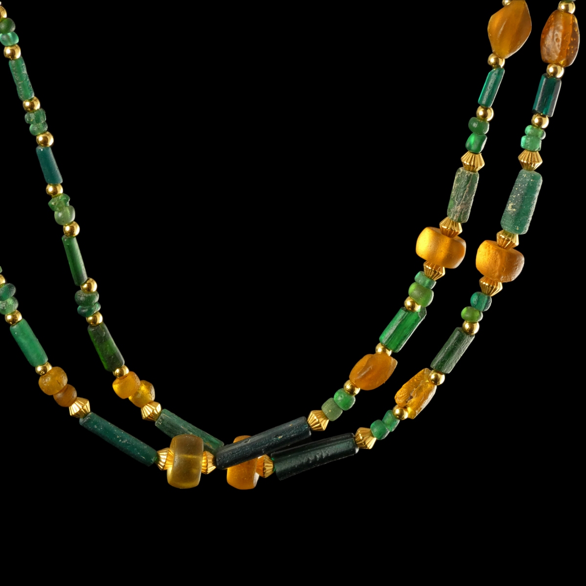 Necklace with Roman green and amber coloured glass beads