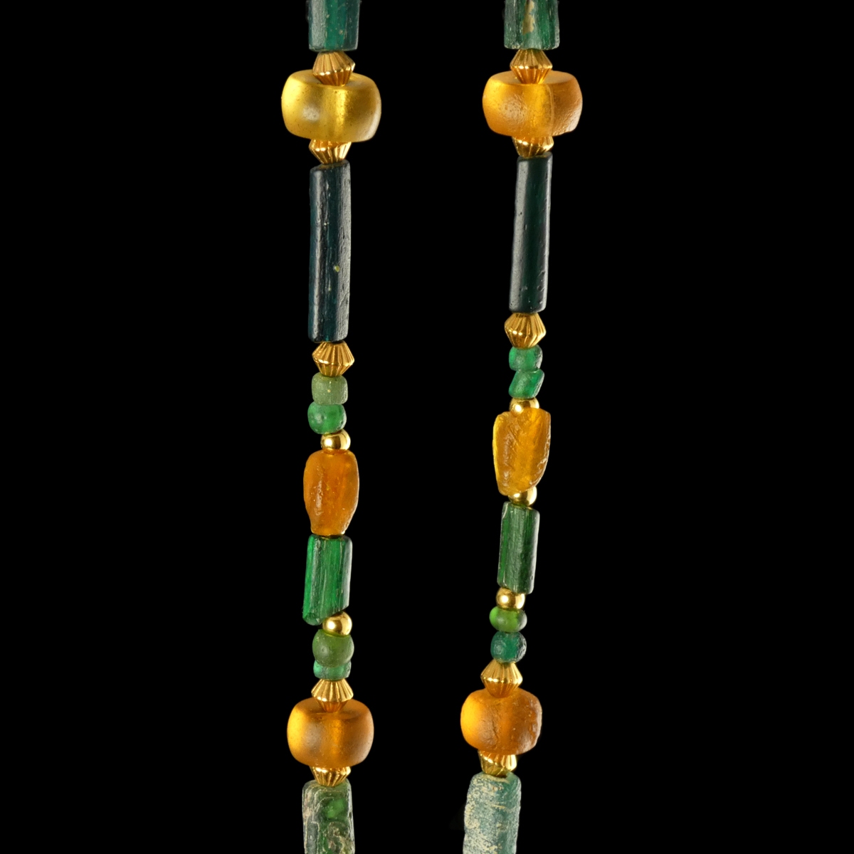 Necklace with Roman green and amber coloured glass beads