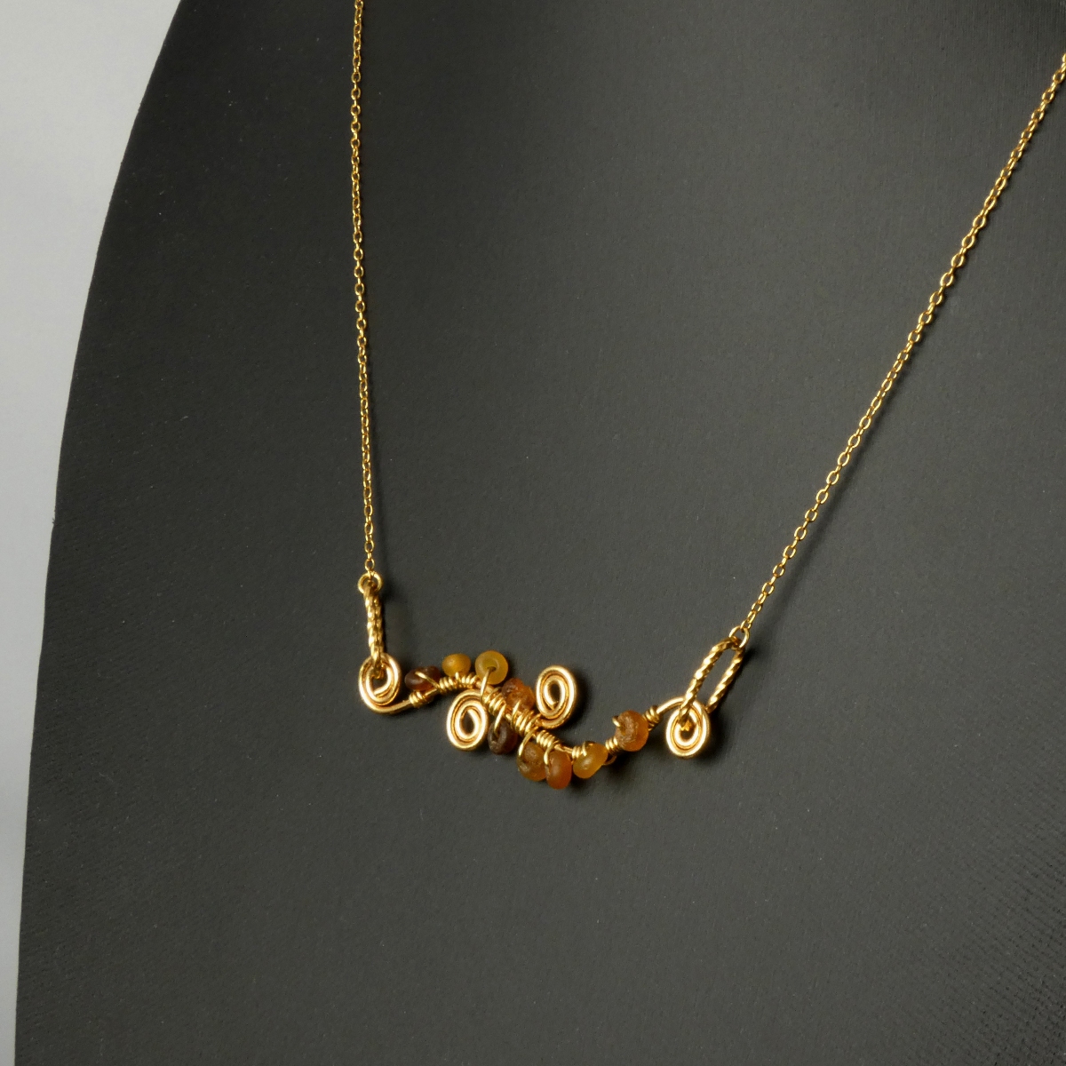 Necklace with wire-wrapped Roman amber glass beads and spiral details