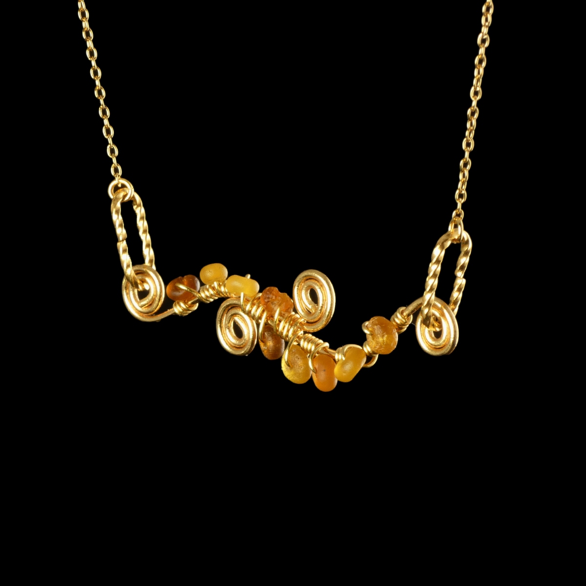 Necklace with wire-wrapped Roman amber glass beads and spiral details