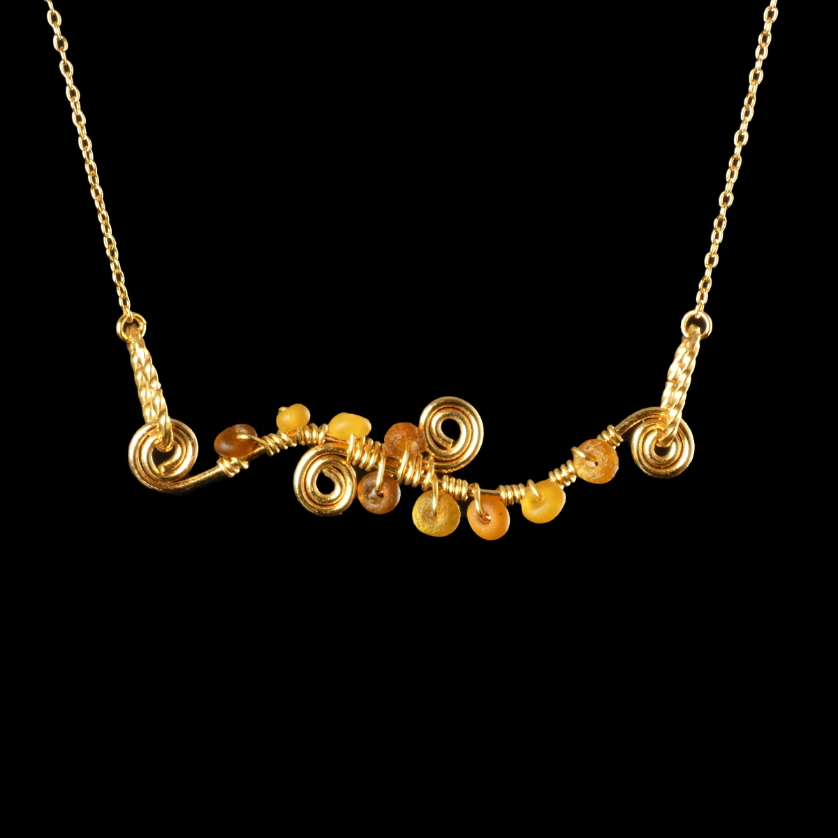 Necklace with wire-wrapped Roman amber glass beads and spiral details
