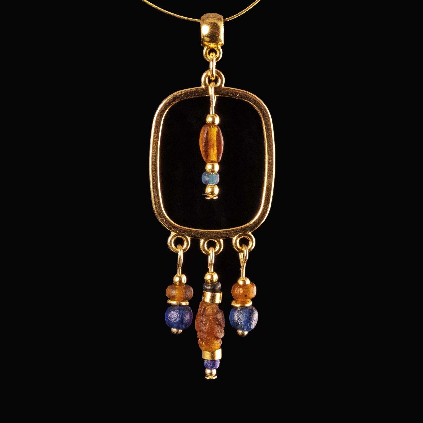 Pendant with Roman blue and amber coloured glass beads