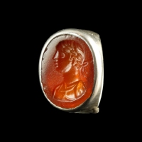 Ancient Roman carnelian intaglio with bust of Apollo, set in silver ring