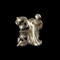 Late Medieval silver openwork dress hook with female figure and floral decoration